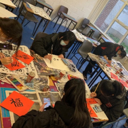 Loreto College Bray TY students at a Chinese calligraphy work